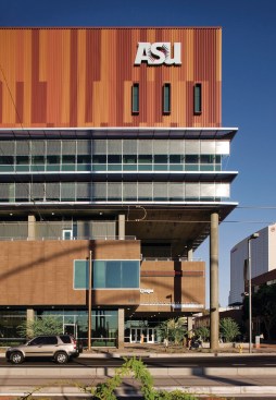 The Cronkite School's most arresting façade treatment is its painted corrugated-metal siding. The colors reference the surrounding arid landscape, but the pattern is a riff on the FCC's radio spectrum chart, an allusion to the broadcasting training that happens within. SIDING - Metal Sales Manufacturing - Corrugated Metal Siding - mtlsales.com - SUNSHADES - GKD Metal Fabrics - Vertical stainless steel sunshading system - gkdmetalfabrics.com