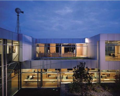 The new offices face either the central courtyard or a restored wetland to the south. The subtle palette of glass and custom light-gray recycled aluminum panels complements the stone of the original Brooks Farm.