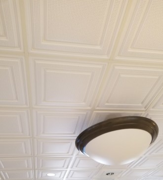 The Stratford panel has a shallow coffered design that gives the ceiling scale and and style. The fine perforations improve its acoustics. Even with glancing sidelight, the thin thermoformed panels lay flat in the suspended ceiling grid.