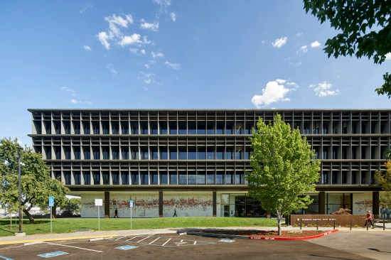 Horizontal louvers on the front of the building are set manually twice a year. They project out at right angles in summer and tilt to 45 degrees in winter.