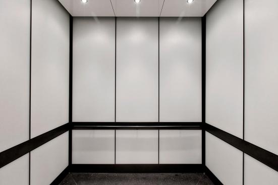 LEVELe-105 Elevator Interior with main panels in ViviChrome Chromis glass with White interlayer and Opalex finish; handrail panels in Fused Graphite with Sandstone finish; Round Handrails in Oil-Rubbed Bronze at the Brandywine Building, Wilmington, Delaware
