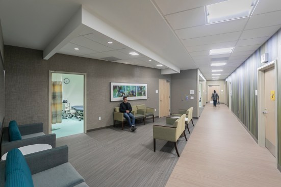 A large-scale artwork by Rica Belna is printed on a rigid wall covering that provides additional visitor protection in the imaging area. The soothing natural tones of the piece are mirrored in the adjacent waiting area.