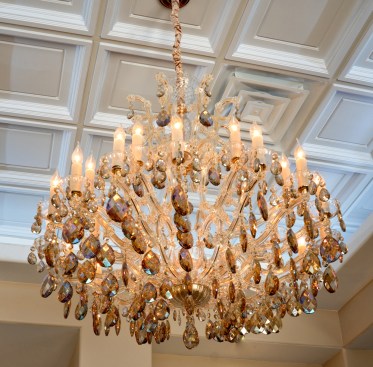 The deep relief ceiling adds elegance and a sense of grandeur that completes the statement of the chandeliers.