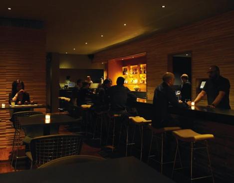The acoustics in the space were a major consideration, especially with the anticipation of crowds of regulars, the performance of music, and the absence of many soft finishes. The solution was to mill strips of Baltic birch plywood and create a varied surface on the walls and the face of the bar. This creates a sculptural visual element, but also helps to diffuse sound.