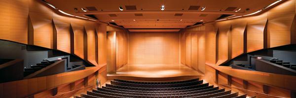 At the beginning and end of a performance, sections of the paneling, including the curved lip of the balcony, begin to glow as LEDs behind them turn on.