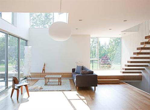 Windows and doors hug the corners of the building, maximizing reflected light within. 
