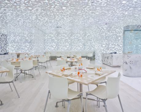 A 0 to 10V dimming system on the LEDs allows a standard lighting control system to set levels for lunch and dinner. The combination of LEDs and halogen sources allows for lighting settings that are traditional or unusual. The light levels reached by using the LEDs are approximately 15 footcandles. The halogen accents add an additional 50 footcandles to the tabletops. Flood beam spreads were used to create an even illumination throughout the restaurant.