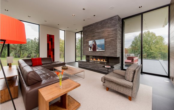Walker Road modern living room with central stacked stone fireplace