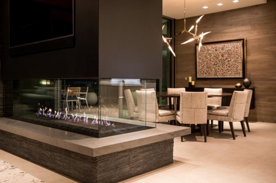 Luxury Beverly Hills home dining room with modern glass fireplace.