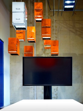 Traditional methods of information storage provides a sculptural setting for learning about new information technology and storage. A “cloud” made of pre-owned filing cabinets suspended from the ceiling represent the transition from paper-based systems to storing information digitally in the cloud.  