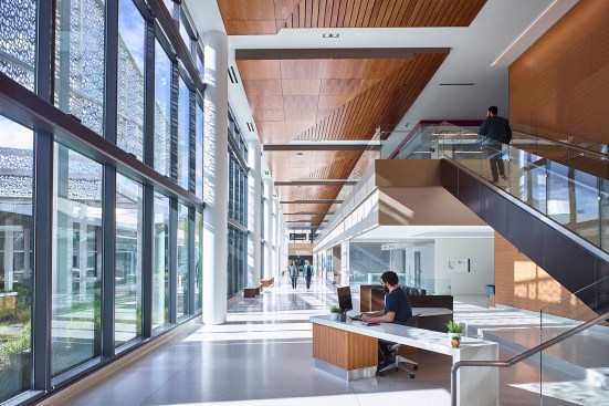 Floor to ceiling windows bring plentiful natural light to the lobby and connecting stair