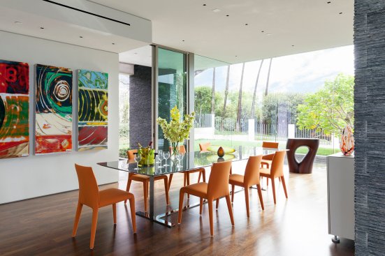 Modern dining room design with glass wall views.