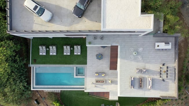 Los Tilos Hollywood Hills modern home lighted pool and outdoor entertainment area.