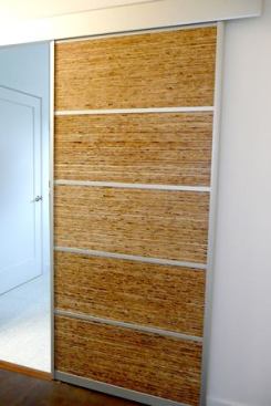 Sliding doors to the master bathroom feature Kirei board, a material created with reclaimed sorghum straw.