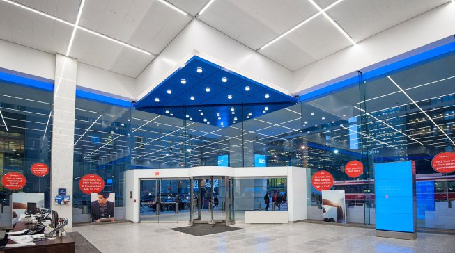 The main entrance is accented with a grid of 27W 3500K decorative-trim downlights in the entry bulkhead.