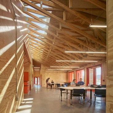 Reception hall with worktables, with classrooms and offices beyond