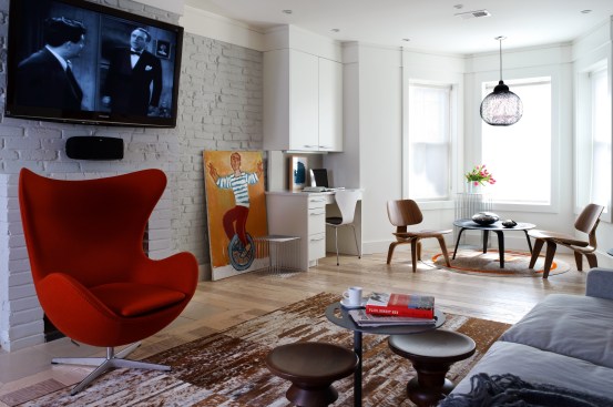 Exposed brick with a white painted finish helps to reflect the minimal light coming in and create consistency for the backdrop of the entire space.