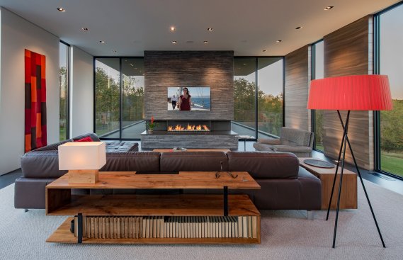 Walker Road modern design home living room with stacked stone fireplace