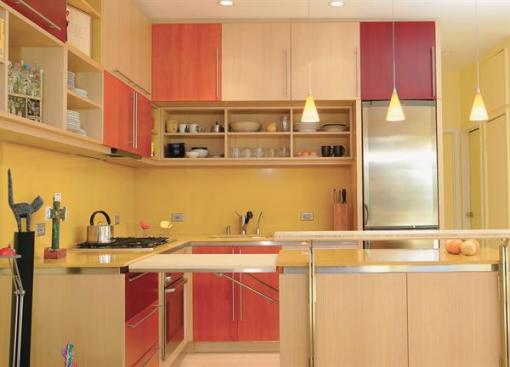 The 24-inch-wide refrigerator is a high-efficiency European model with a freezer on the bottom.