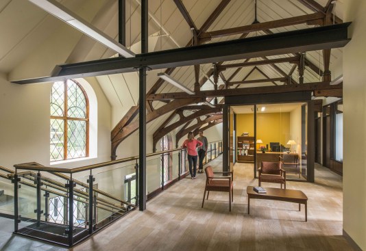open second floor, complete with faculty office space, conference rooms, and student advising space.