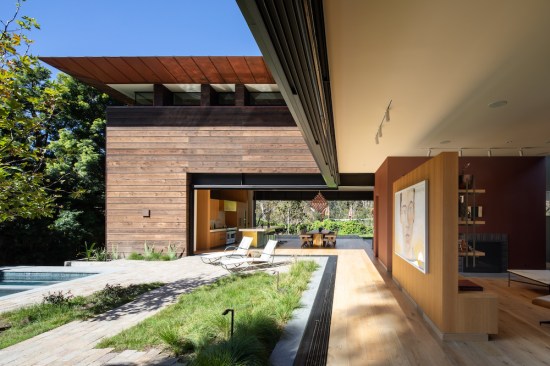 Featuring a large Gus Van Sant watercolor, this central space, with fully pocketing glass and aluminum sliding doors, opens directly to the pool courtyard.