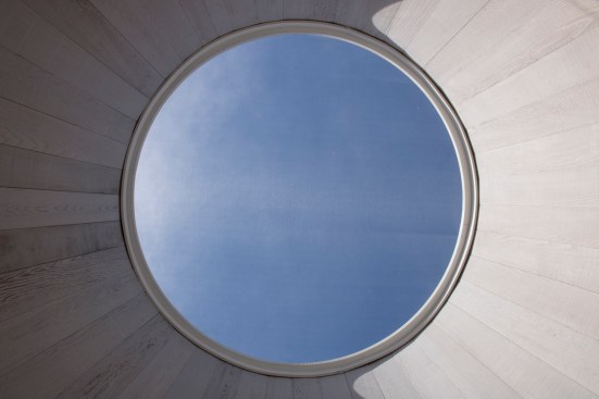 Oculus looking up to roof deck from second floor deck