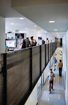 Daylight-harvesting double-height corridor with view to lab spaces