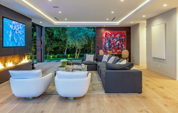 Modern living room with sliding glass walls at luxury Los Angeles home.