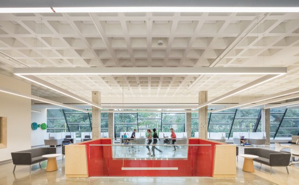 In the north-facing research workspace on the second floor, the architects exposed the existing waffle slab ceiling.