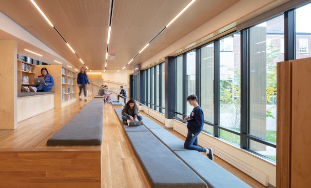 A flexible first-floor amphitheater blends the functions of a library, study room, corridor, and gathering space. Baltic birth plywood furniture provides book storage, study carrels, and lounge seating.