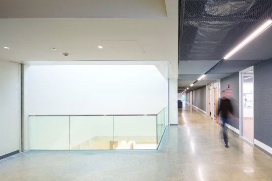 NADAAA added a third floor to the existing library structure to accommodate 10 classrooms and additional breakout space. A light well connects the new level to the research floor below.