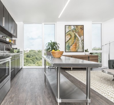 Open-plan living spaces in the one-bedroom units contain American Standard kitchen fixtures and GE appliances.