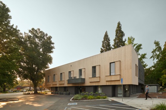 A cedar rain screen finished with a sustainable mineral sealant wraps the existing and the new building volume