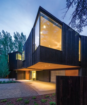 The house is clad in shou-sugi-ban, or burnt cedar boards. Natural cedar lines the deep soffits at the front of the house, which were designed to meet regulations dictated by Aspen’s form-based codes.
