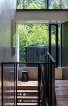 Inside, plaster work on the stairwell wall catches and reflects light into the second-floor hallways. The art on the wall was selected by Bruder as part of a complete interior design for the spec project.