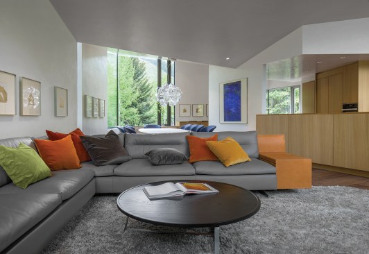 Much of the second floor is open-plan, featuring a living area, dining area (seen beyond), and kitchen.