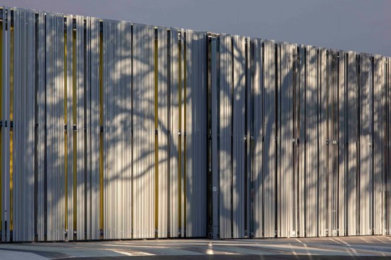 The wall, made of metal panels, acrylic, and mirrors