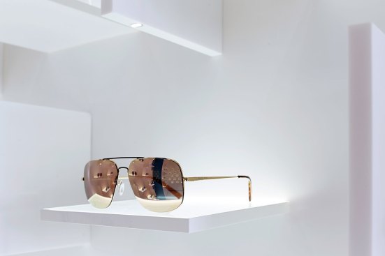 A detail of the display shelves; each pair of eyeglasses is illuminated via the vertical "fin" above.