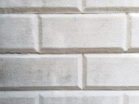 A close-up of the wood siding at the Mount Vernon Estate shows the effect of sand-casting to mimic stone.
