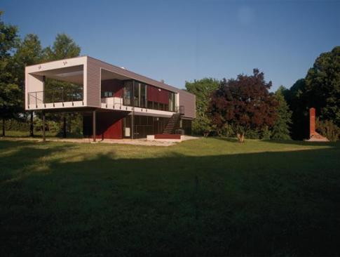 An existing prefabricated house was demolished, but the fireplace remains as a ruin behind the house. 