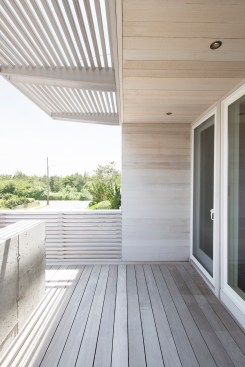 Front porch with poured concrete wall, cedar siding, and cedar brise soleil
