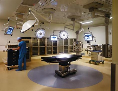 The first floor of the building plays host to several general surgery operating rooms. In order to maintain a sterile environment, resilient flooring and wipeable metal fixtures outfit the spaces. Resilient flooring: Nora; Noraplan Mega in Arctic Ice and Toffee; norarubber.com - Paint: Sherwin-Williams; Interior paint; sherwin-williams.com