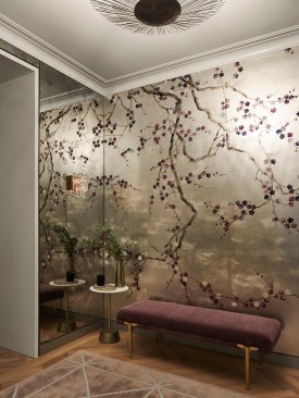 The foyer is cladded with antique mirrors or 3 sides and a hand-painted wallpaper on 1 side