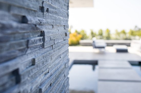 Stacked slate stone wall detail at luxury Beverly Hills home.