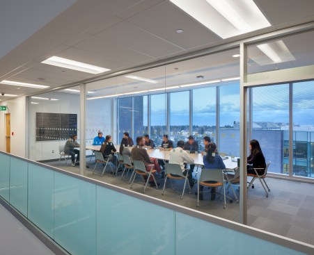 Collaborative meeting spaces line the five-storey atrium.