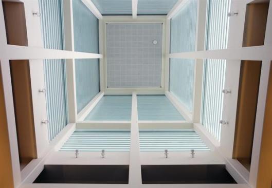 View into the channel-glass-enclosed tower from the museum lobby.
