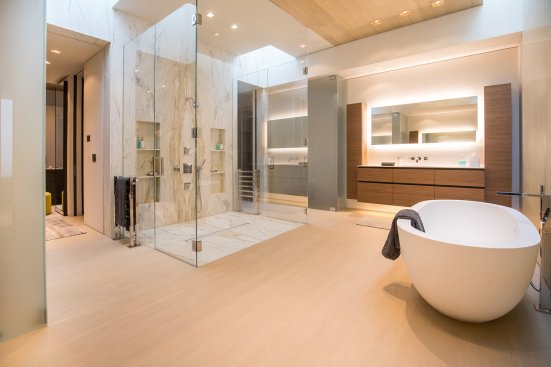 Luxury Beverly Hills bathroom with soaking tub and marble shower.