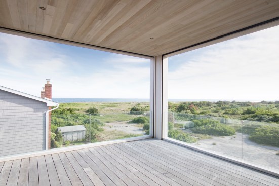 Covered deck off living space with views to the water