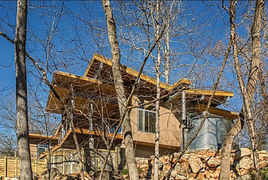Deep roof overhangs protect the house's extensive glazing from the high summer sun.