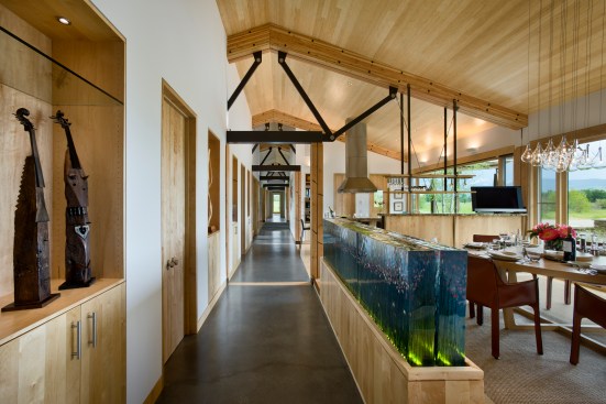 Interior, horizontal, overall dining room and kitchen areas looking down hallway, Kahlbetzer residence, Wilson, Wyoming; Ward + Blake Architects